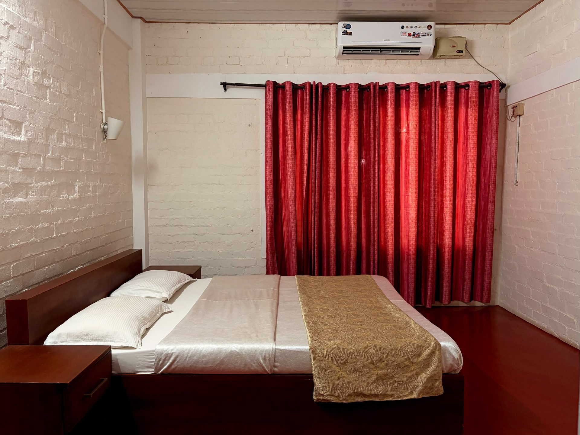 Poomukham bed with red curtains